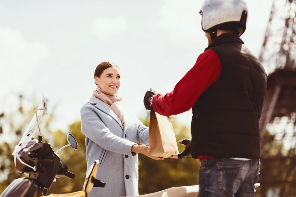 Meal Delivery Concept. Cheerful Woman Receiving Package With Food Order